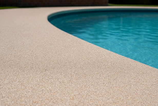 Slip-resistant pool deck coating providing safety for families around a residential swimming pool in Whitman, MA.